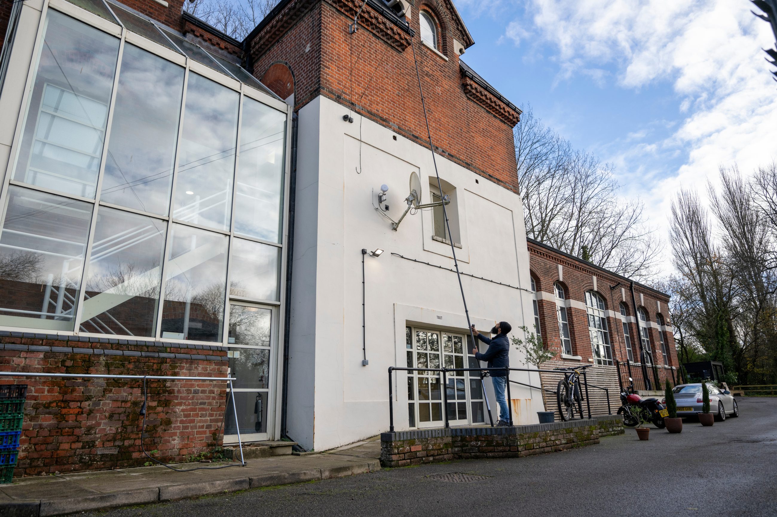 External shot of a solicitors firm, white walls and glass panes with dilapidations surveyor from Bressummer A.R.K conducting a dilapidation survey