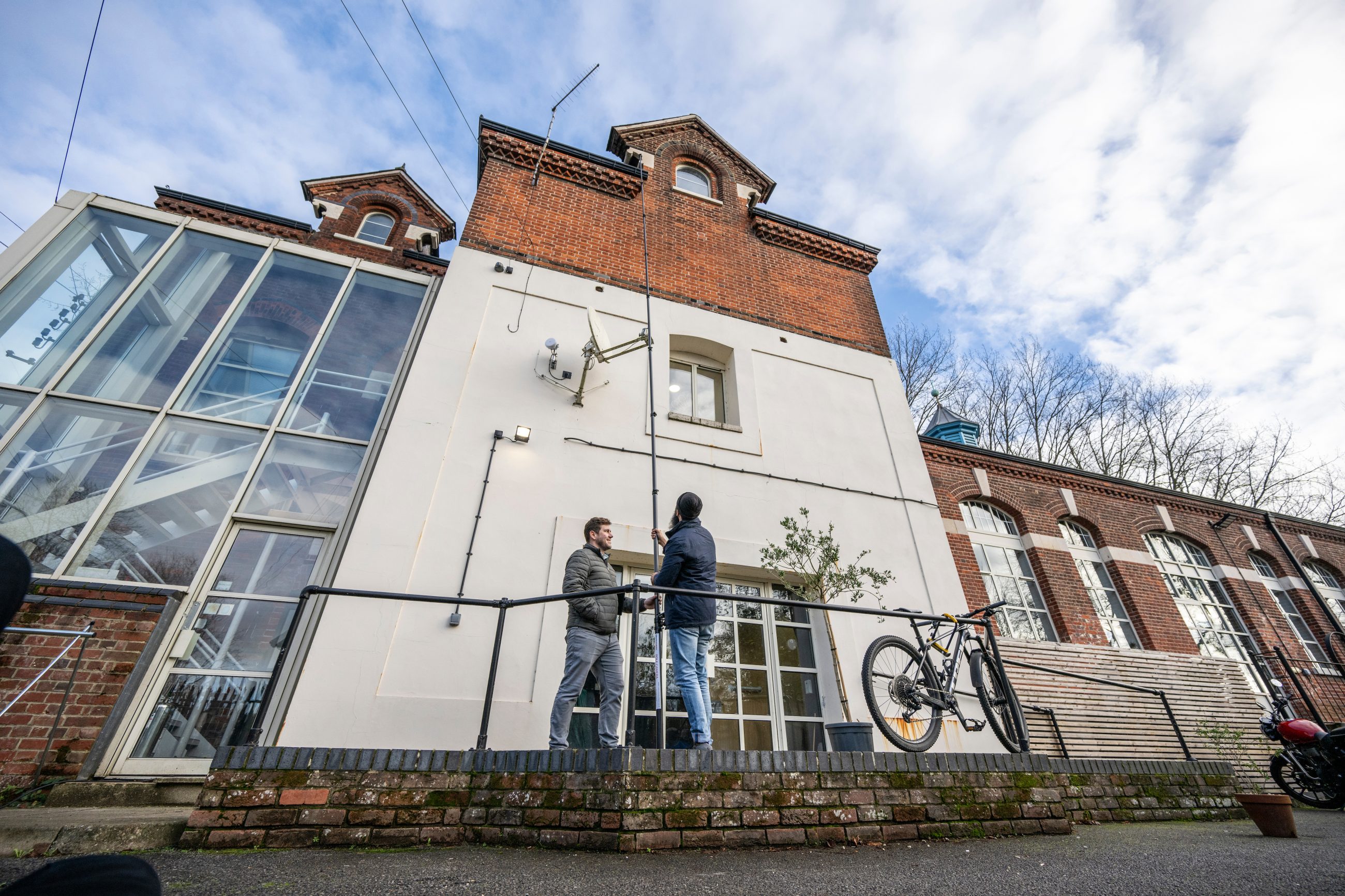 Two chartered building surveyors carrying out a commercial building survey on a modern office unit