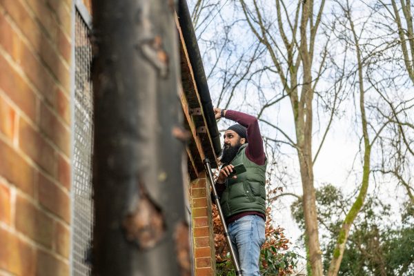Bressummer A.R.K's commercial surveyor, Harjit, on a ladder conducting survey on an old commercial building