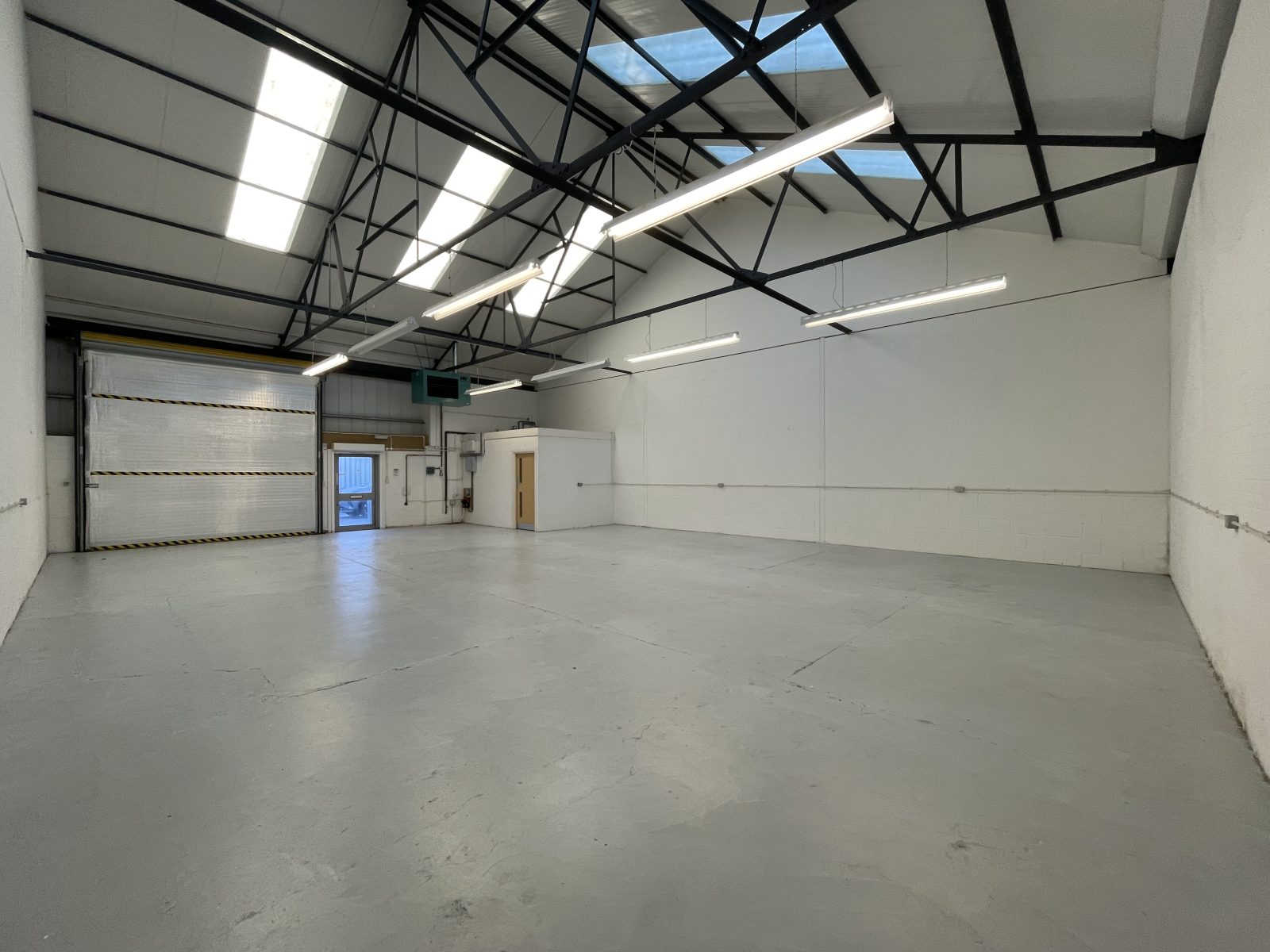View of an empty warehouse area in an industrial property on a schedule of condition inspection.