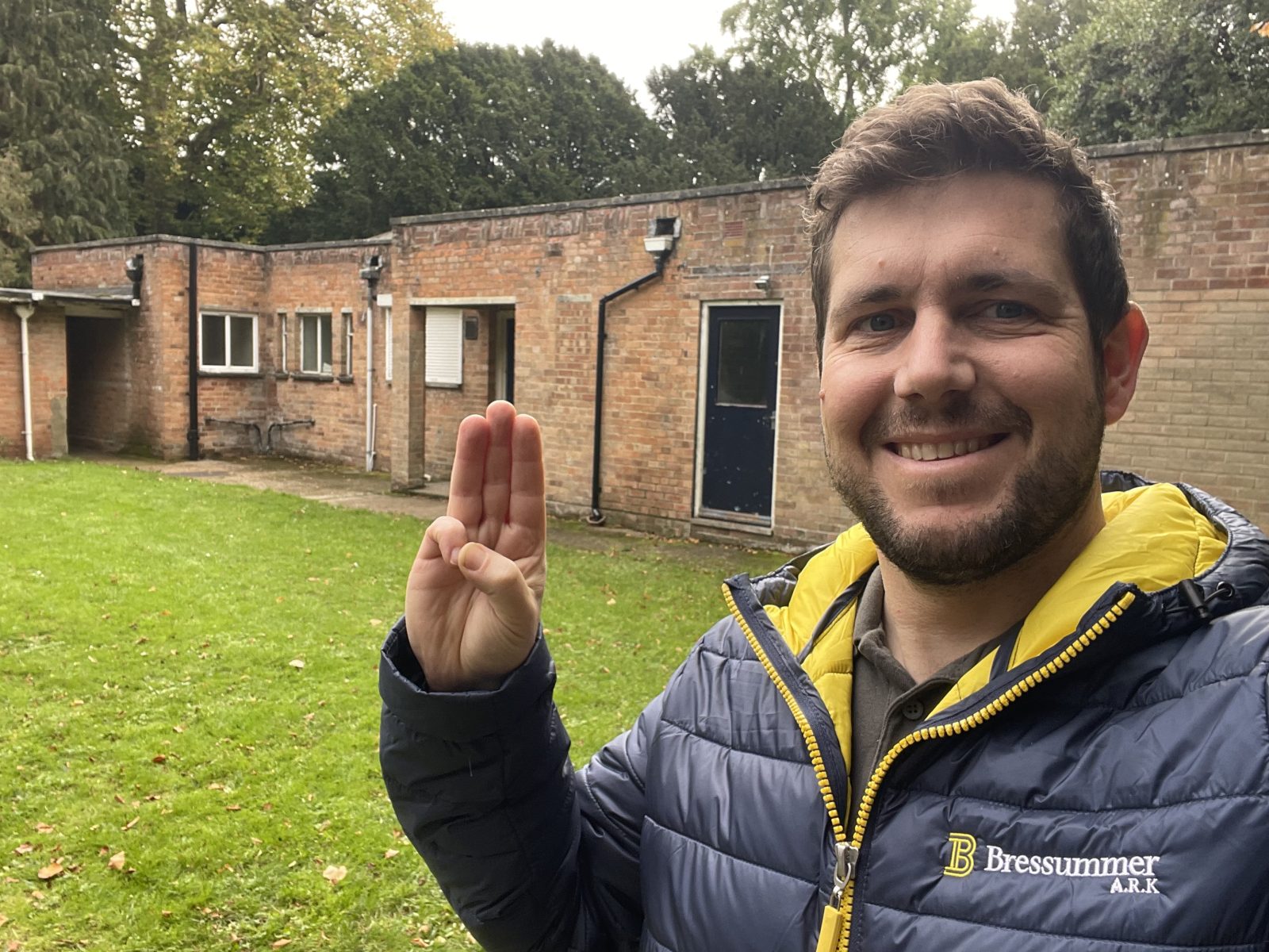 Chartered building surveyor taking a selfie with the building in the background.