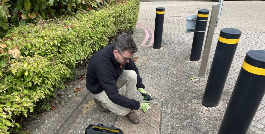 Steve Willington MRICS inspecting the underground drainage system during a commercial building survey in Hampshire.