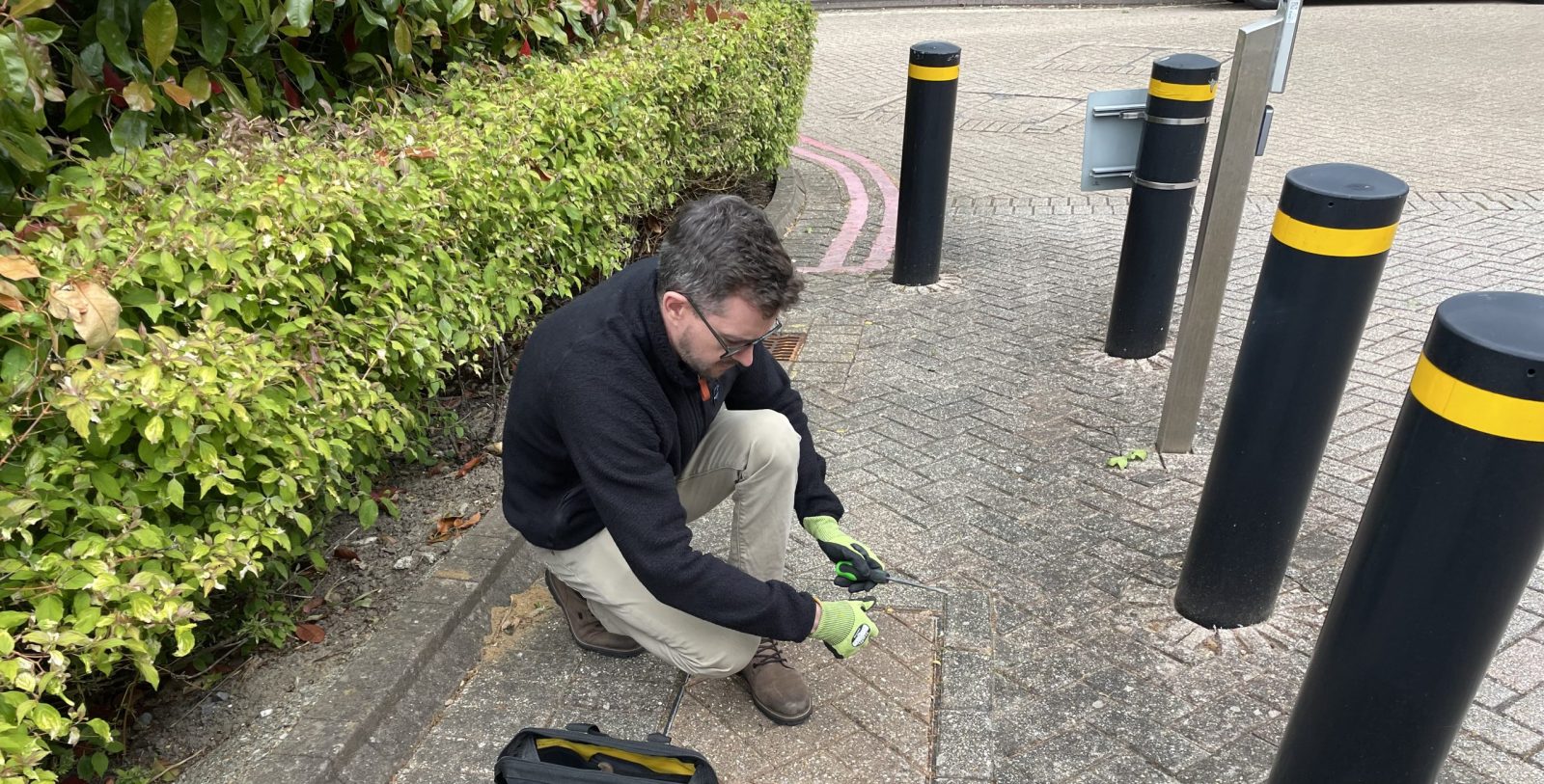 Steve Willington MRICS inspecting the underground drainage system during a commercial building survey in Hampshire.